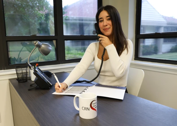 CRN staff member on the phone at her desk